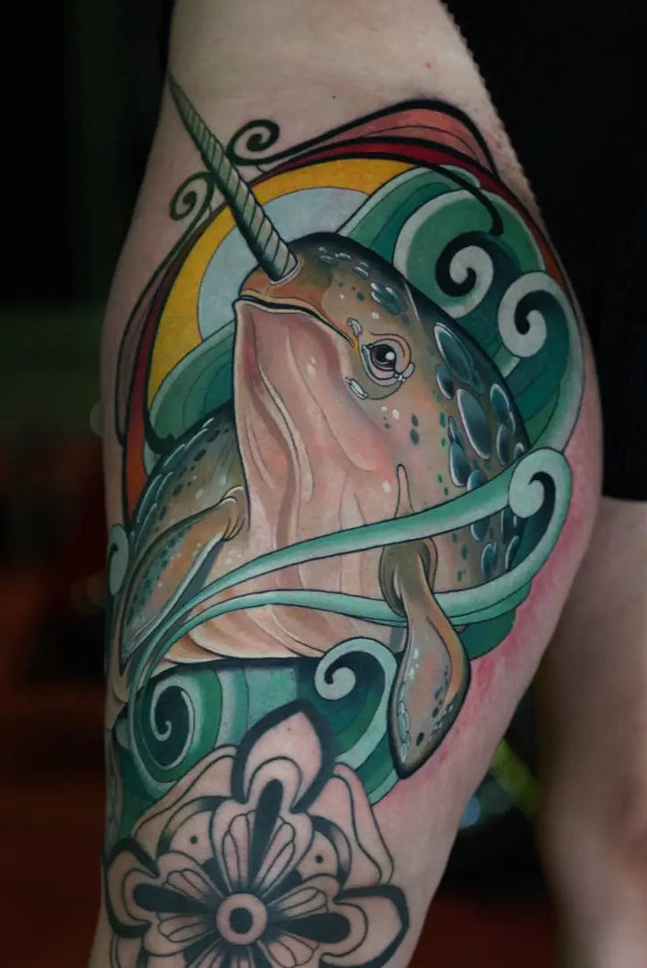tatuaje en el muslo de un narval a color en neo tradicional